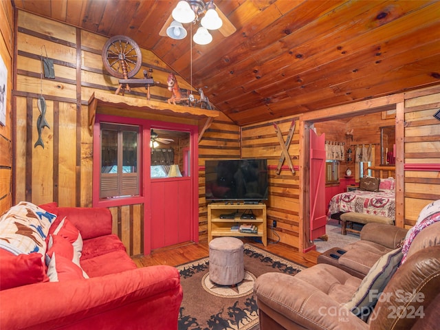 living room with wood-type flooring, wood ceiling, vaulted ceiling, wood walls, and ceiling fan