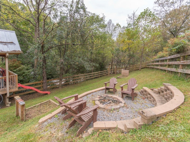 view of yard with a playground and an outdoor fire pit