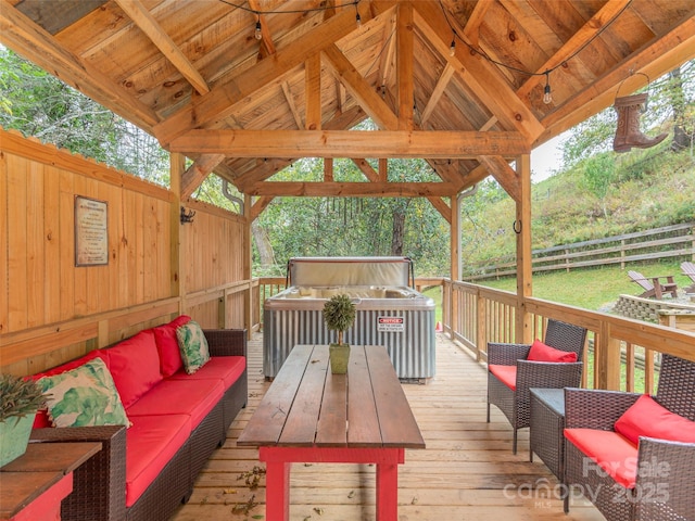 wooden deck with a gazebo, an outdoor living space, outdoor dining space, and fence