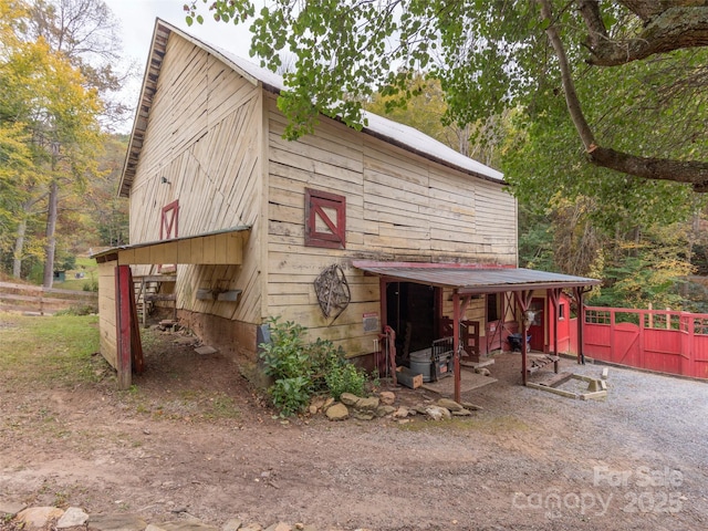 view of barn with fence