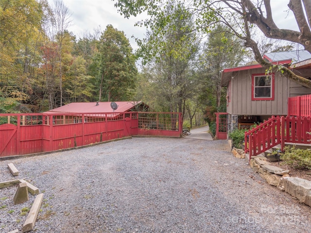 exterior space with driveway and a gate