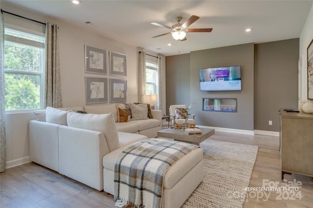 living room featuring light wood-type flooring and ceiling fan