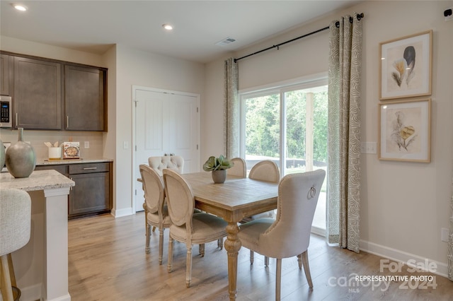 dining area with light hardwood / wood-style flooring