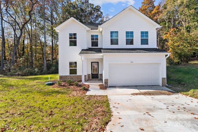 view of front of house with a front yard and a garage