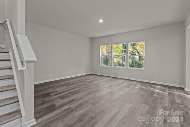 1403 Gentry Pl, Salisbury, NC 28146 - unfurnished living room featuring stairway, baseboards, wood finished floors, and recessed lighting