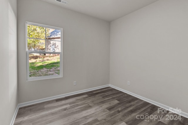 unfurnished room with wood-type flooring