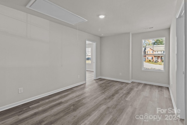 empty room with hardwood / wood-style flooring