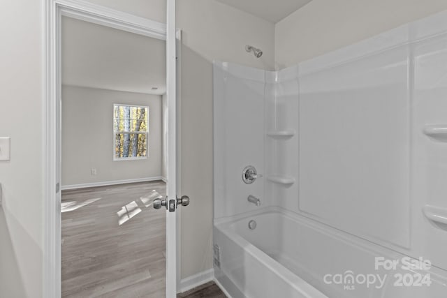 bathroom featuring shower / washtub combination and hardwood / wood-style floors