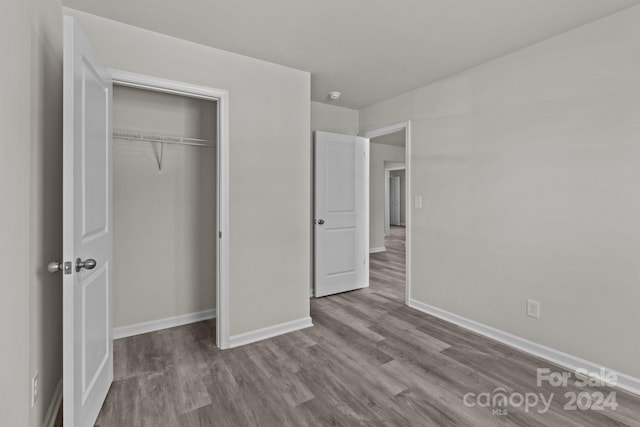 1403 Gentry Pl, Salisbury, NC 28146 - unfurnished bedroom with wood finished floors, baseboards, and a closet