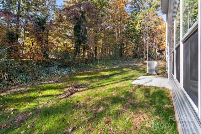 view of yard featuring a patio and central AC unit