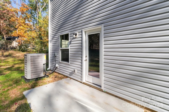 exterior space featuring central air condition unit and a patio area