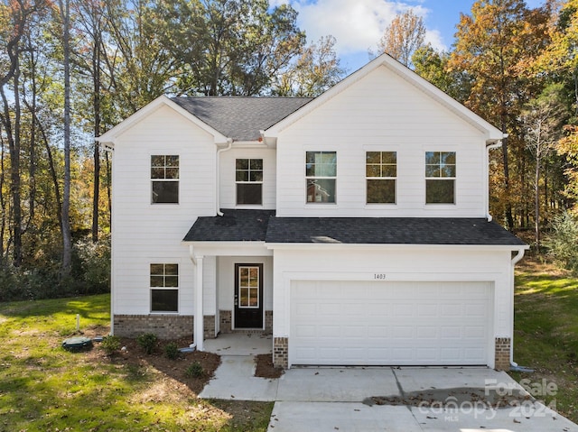 view of front facade with a front yard and a garage