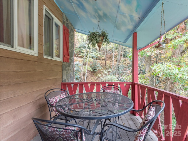 wooden terrace featuring outdoor dining space
