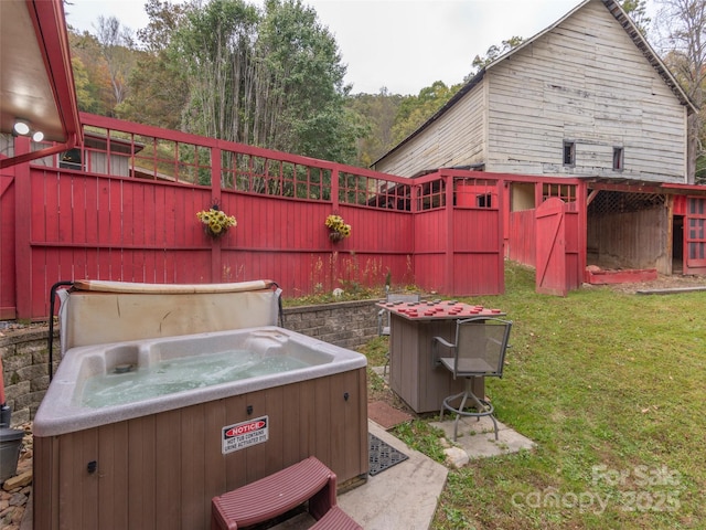 view of yard featuring fence and a hot tub