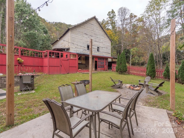 view of patio / terrace featuring a fire pit, fence, and outdoor dining space