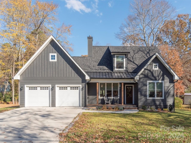 view of front of property with a front lawn, a porch, and a garage