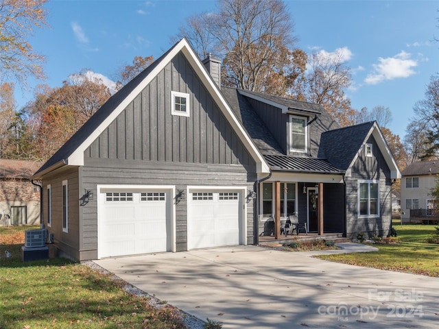 view of front facade with central air condition unit, a front yard, a porch, and a garage