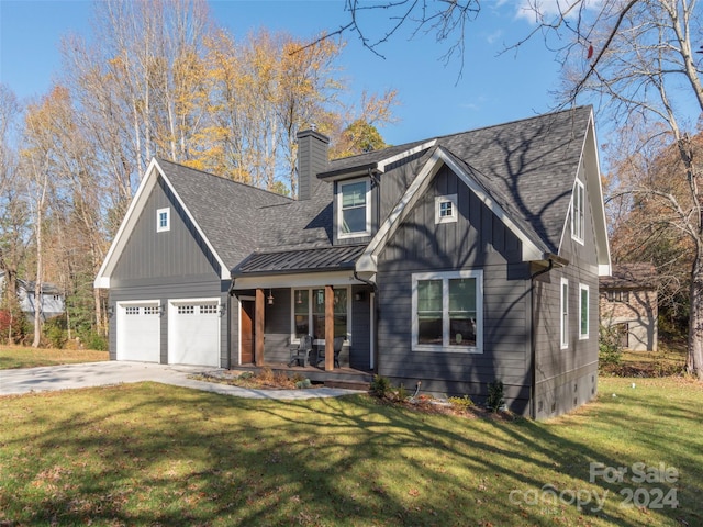 craftsman house with covered porch, a front yard, and a garage