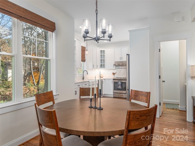 dining space featuring a chandelier and light hardwood / wood-style floors