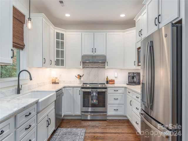 kitchen featuring pendant lighting, white cabinetry, dark hardwood / wood-style flooring, and stainless steel appliances