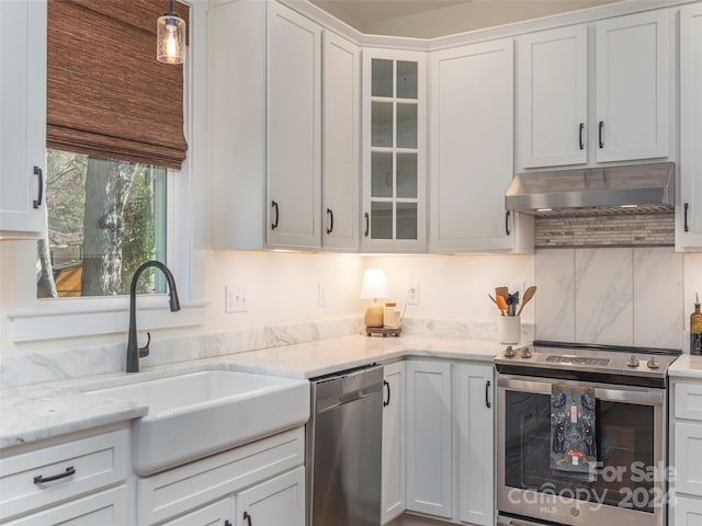 kitchen featuring pendant lighting, white cabinets, stainless steel appliances, and sink