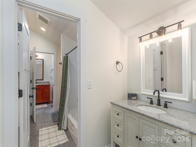 bathroom with shower / bath combo with shower curtain, vanity, tile patterned floors, and lofted ceiling