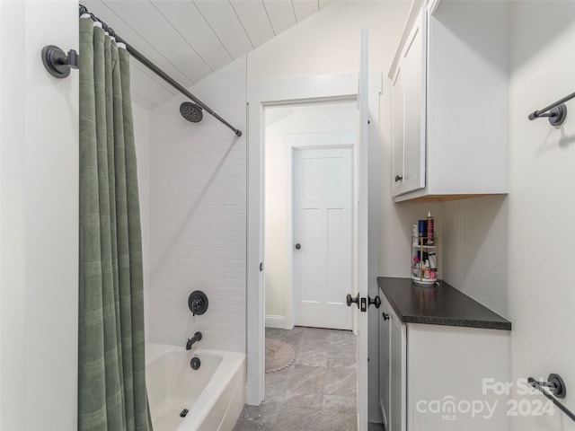 bathroom with shower / bath combo with shower curtain and lofted ceiling