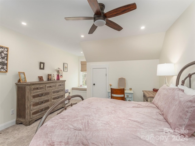 carpeted bedroom with ceiling fan and vaulted ceiling