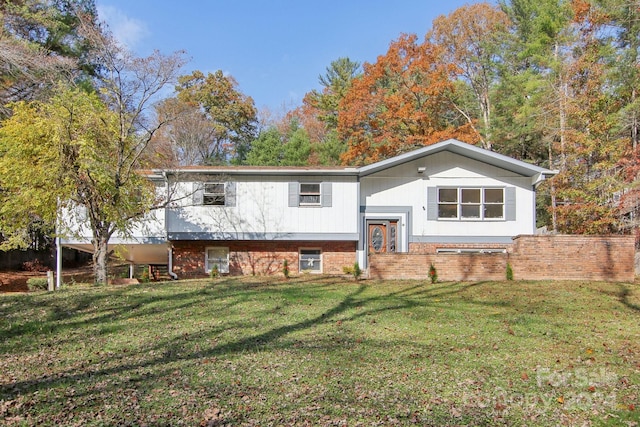 raised ranch featuring a front lawn