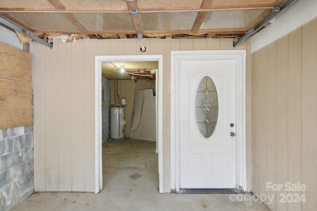 view of exterior entry featuring water heater