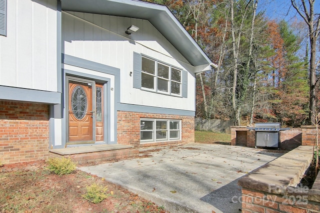 821 Anne Ave W, Hendersonville, NC 28739 - view of exterior entry with brick siding and a patio