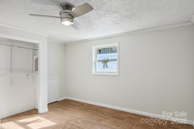 821 Anne Ave W, Hendersonville, NC 28739 - unfurnished bedroom featuring ornamental molding, wood finished floors, a closet, a textured ceiling, and ceiling fan