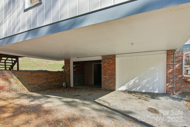821 Anne Ave W, Hendersonville, NC 28739 - property entrance featuring an attached carport and brick siding