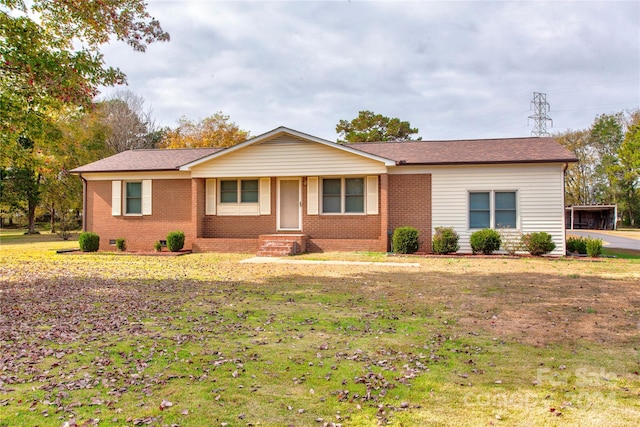 ranch-style house with a carport and a front lawn