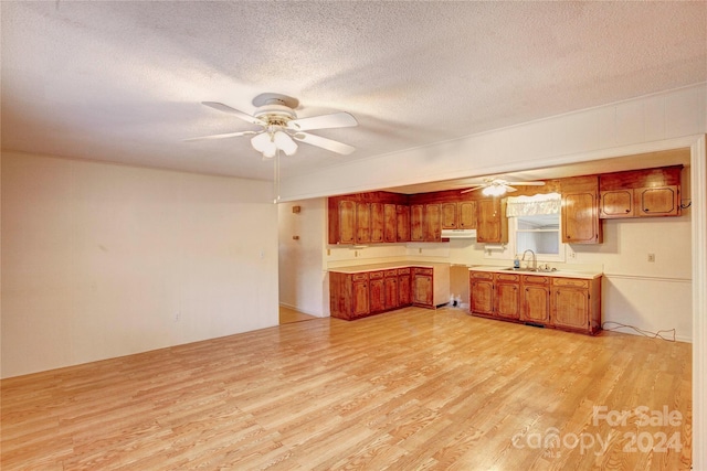 kitchen featuring light hardwood / wood-style flooring and a textured ceiling