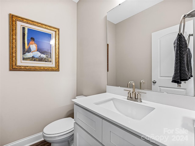 bathroom featuring toilet and vanity