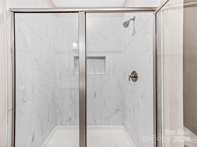 bathroom with walk in shower and toilet