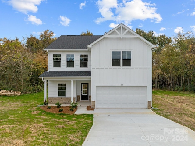 view of front of home featuring a front yard and a garage