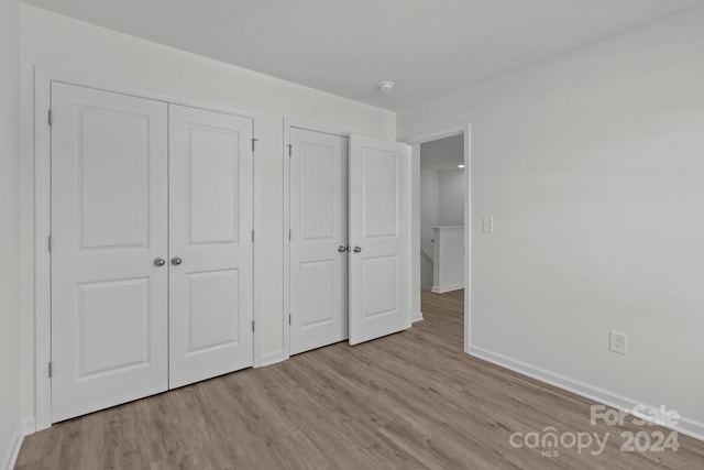 unfurnished bedroom with light hardwood / wood-style floors