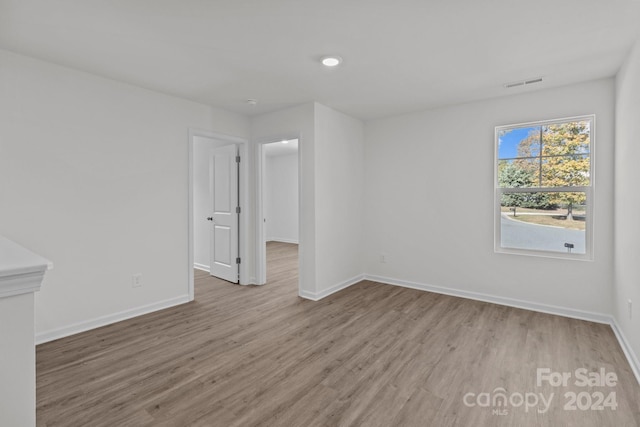 spare room with light hardwood / wood-style flooring