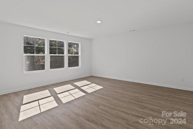 empty room with hardwood / wood-style flooring