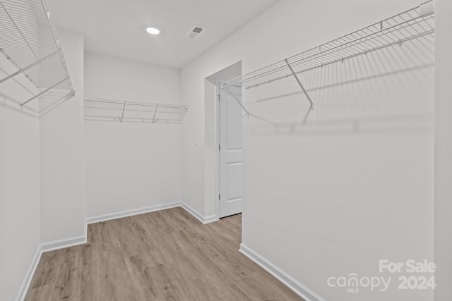 walk in closet featuring light hardwood / wood-style floors