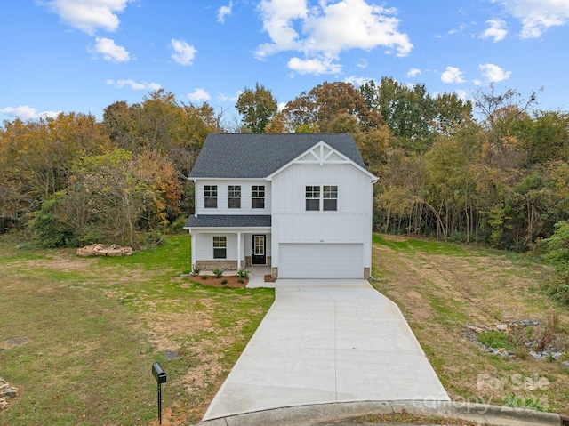 view of front of house featuring a front lawn and a garage