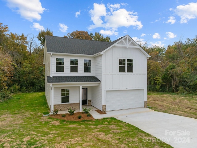 view of front of property with a front lawn and a garage