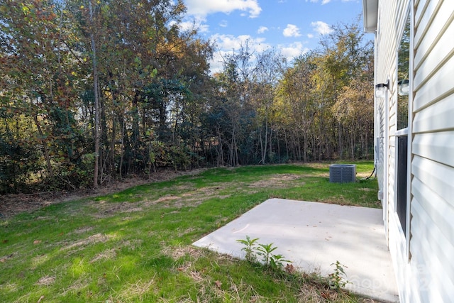 view of yard with cooling unit and a patio area