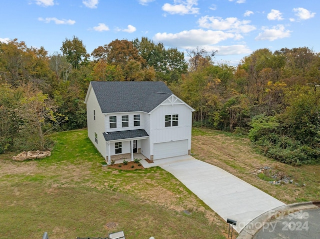 view of front of house with a front yard and a garage