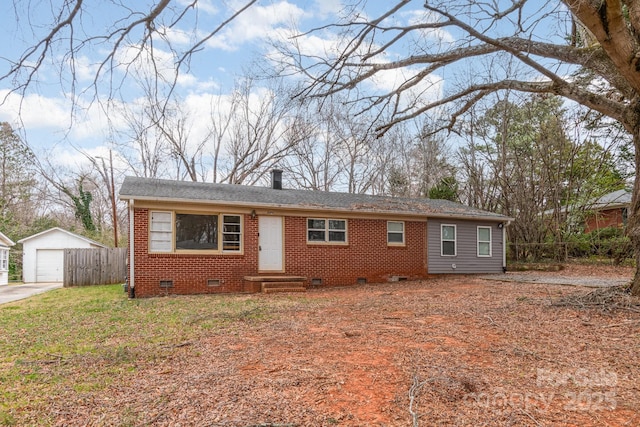 view of front of property featuring an outbuilding, a chimney, a garage, crawl space, and brick siding
