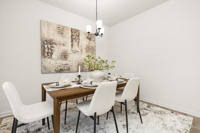 dining area featuring a chandelier and hardwood / wood-style floors