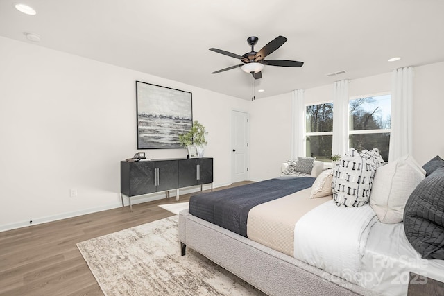 bedroom with wood-type flooring and ceiling fan