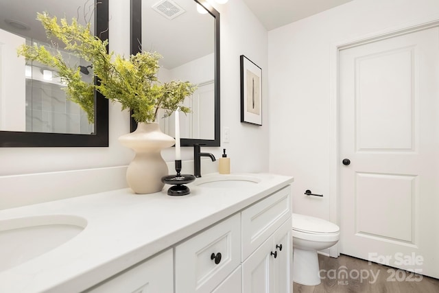 bathroom featuring hardwood / wood-style flooring, vanity, and toilet